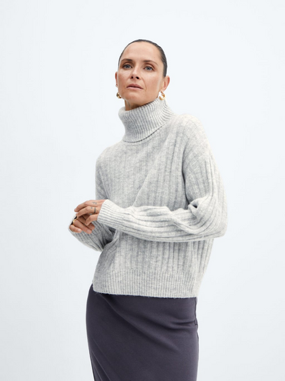 Rolled neck cable sweater