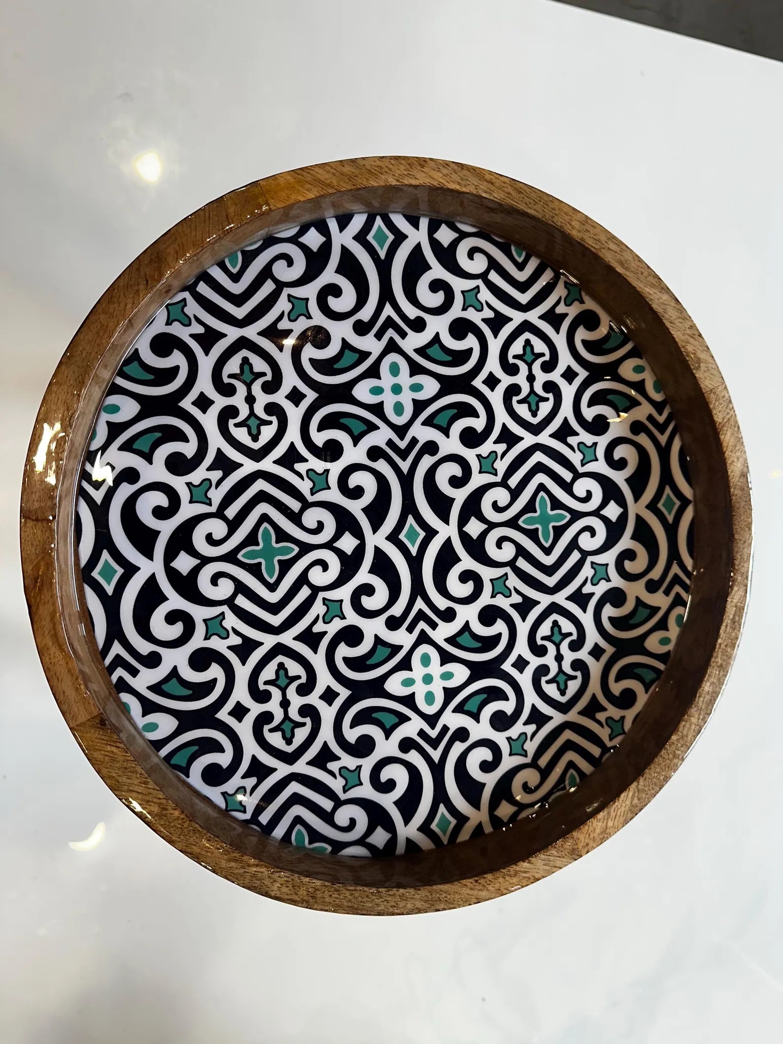Decorative Artisan wooden coffee with a geometric pattern on a white surface