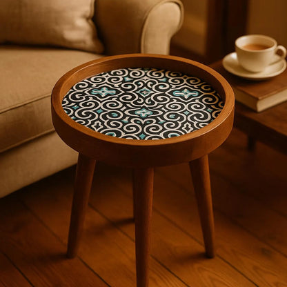 Round wooden side table with a patterned top in a cozy room setting.