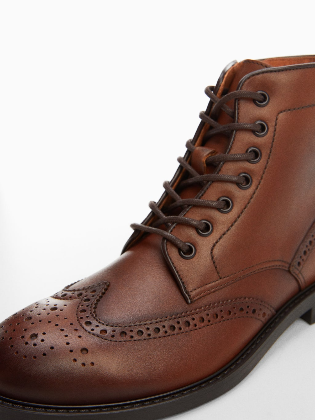 Die-cut leather ankle boots